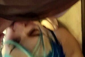 This is a video made of a girl with blue hair performing oral sex and she gets cum on her face and in her mouth